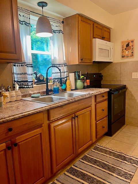 The kitchen is a large galley space that comes with extras such as an ice cream maker, mini waffle maker, griddle, blender, juicer, popcorn popper, and air fryer. Utensils, plates, cups, glasses, oven mitts, and a full spice rack. Plus a Coffee Bar. (Photos to come)