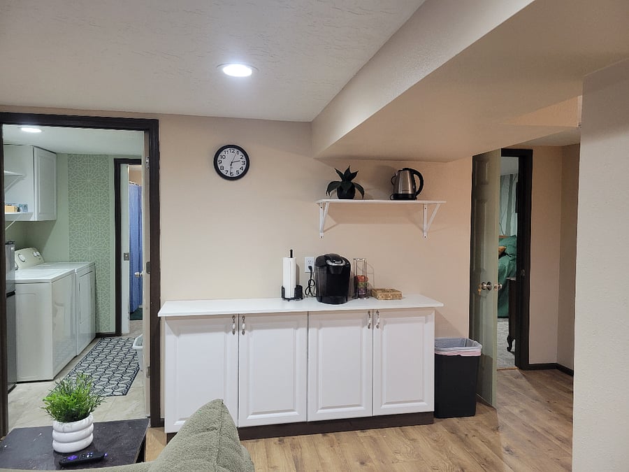 Coffee bar, laundry room/bath (left), private bedroom door (right)