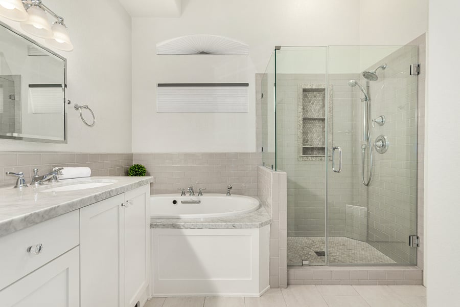 Primary bathroom with tub, stand-up shower, and duel sinks