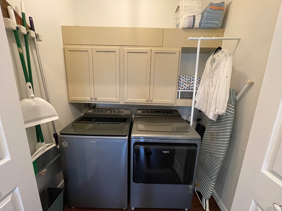 Washer, dryer, ironing board and additional storage.