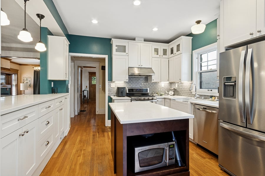 Kitchen with full-sized fridge, dishwasher and double gas oven and range