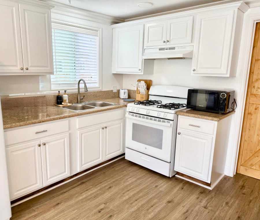 Fully equipped kitchen with stove, microwave and full sized fridge