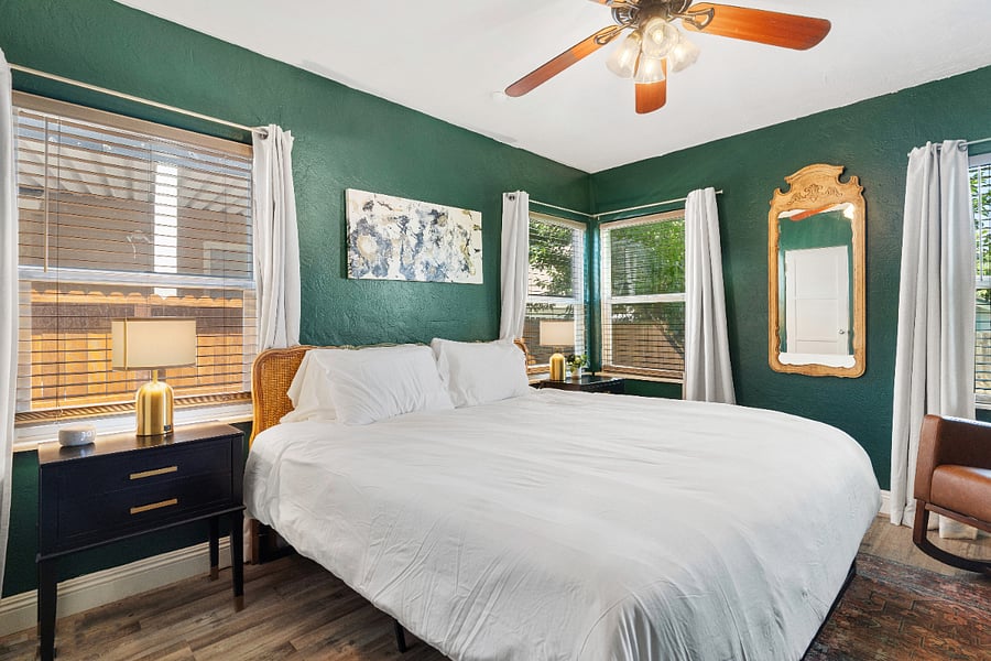 King bedroom surrounded with windows