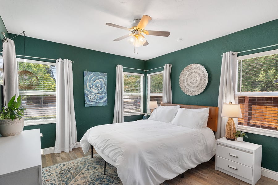 Queen bedroom surrounded with windows