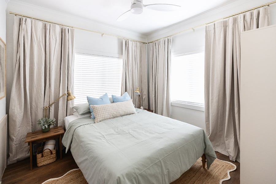 bedroom #2 with windows into the backyard and blackout curtains with blinds.