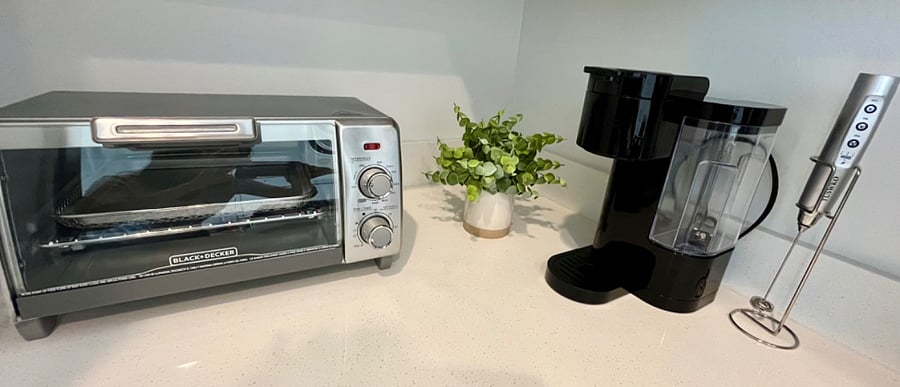 Toaster oven, Keurig coffee maker, pots, pans, crockpot, electric can opener, dish/glassware, utensils, and more.