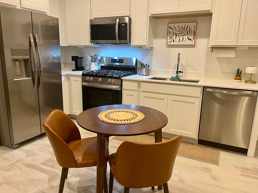 Full-size appliances: refrigerator with filtered water & ice door dispenser, gas stove/oven, microwave, and dishwasher. 