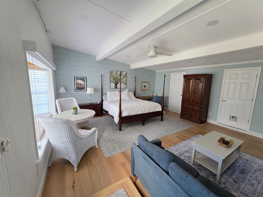 multiple furniture layouts possible, with sofas, chairs and table