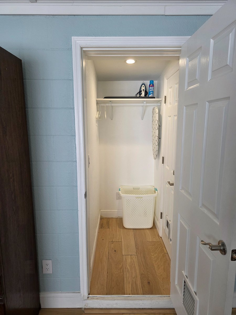 Ironing necessities and laundry basket. Any unneeded items can be removed.