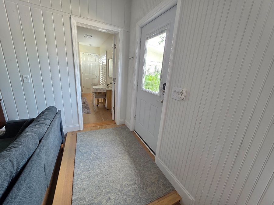 Step up area to back door with view of shared courtyard.