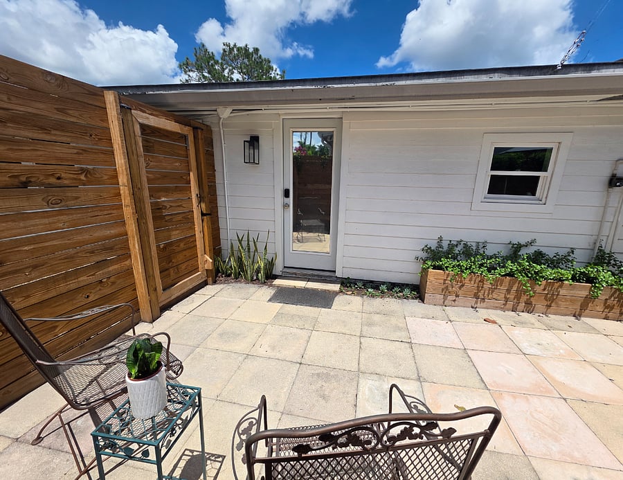 Inside patio: Entry door with coded lock. Two garden chairs have gently bouncing rock for relaxation.