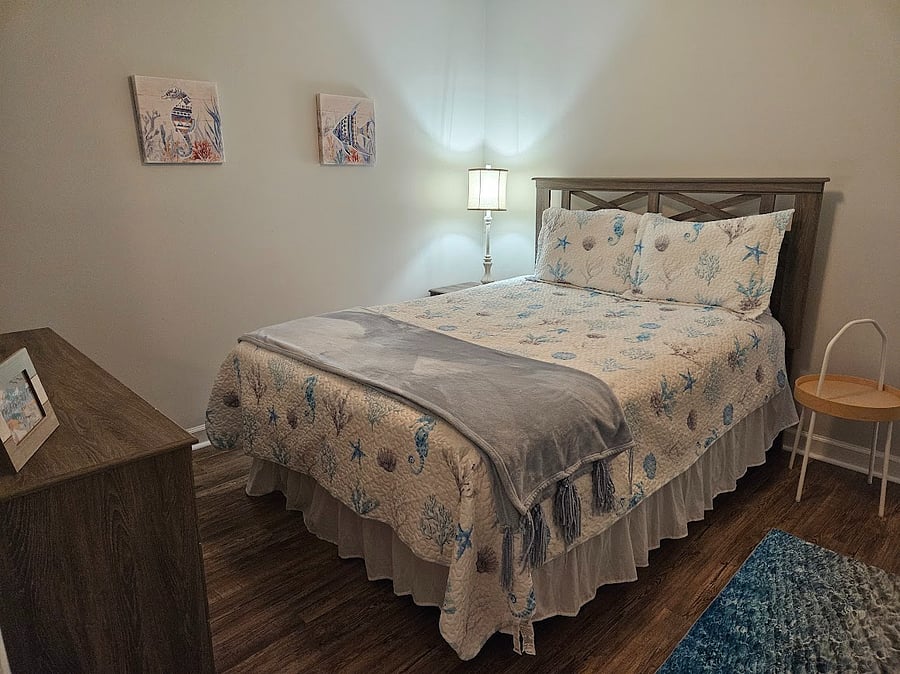Bedroom 1: Features Blackout Curtains, Comfortable Bed, Full Dresser, Closet, and Ceiling Fan