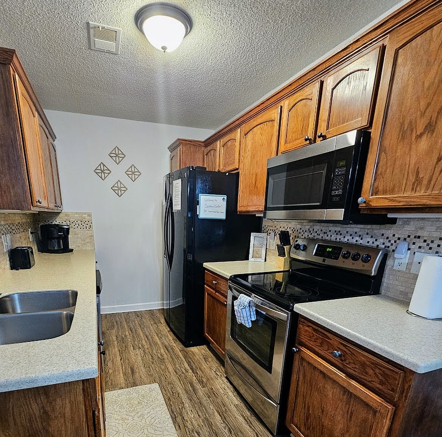 Fully stocked kitchen! Full size fridge, oven, microwave, & dishwasher!