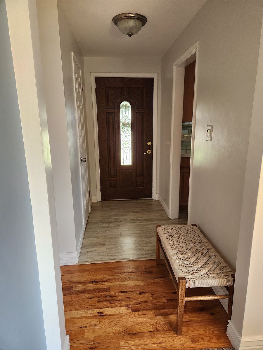 Front entry, kitchen to one side, to the other, coat closet with cordless vacuum, other cleaning tools.
