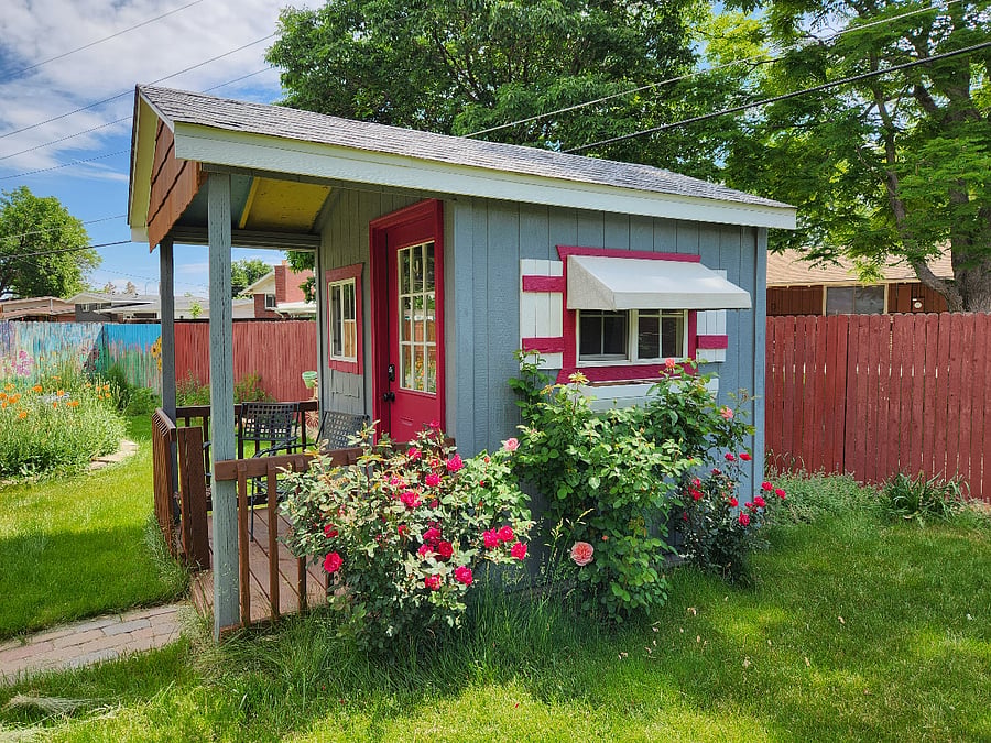 Rose bushes align the shed. Watch out for thorns!