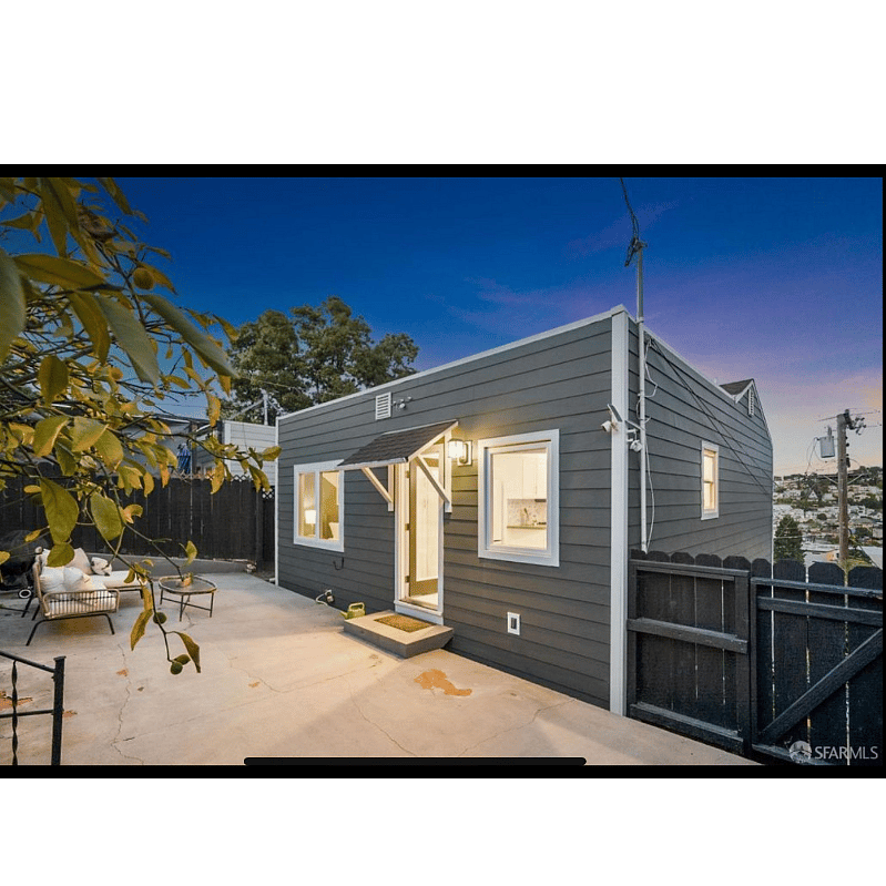 The kitchen door opens out onto the back yard, receives lovely afternoon sun and has steps leading up to the private driveway.