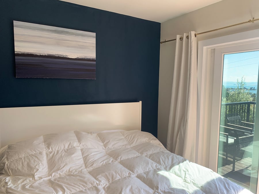Bedroom # 2 opens to the front patio with bay views. This room has a kind bed and also a tv.