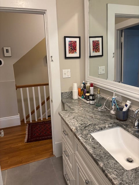 bathroom has beautiful granite counter tops and a large mirror