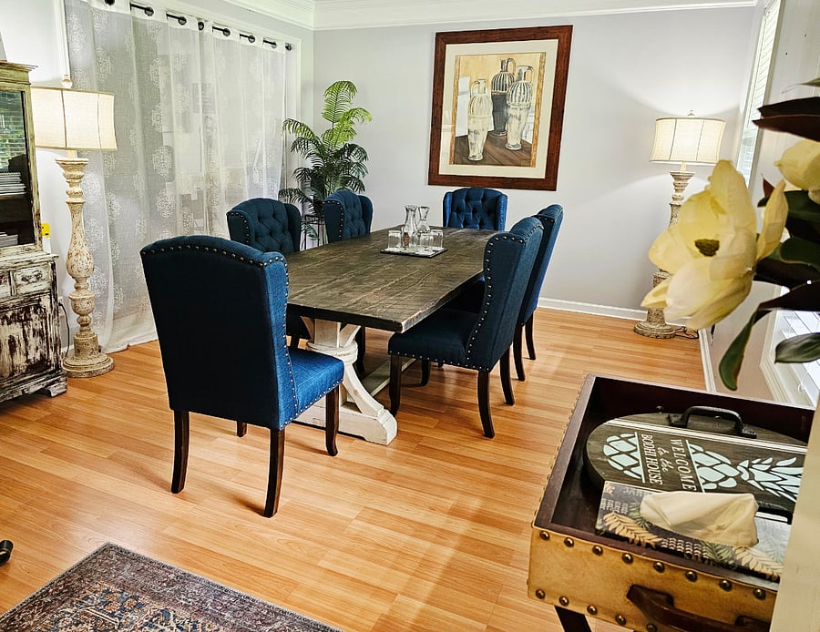 Dedicated dining area with large table seating up to 8, ideal for sharing meals or workspace.