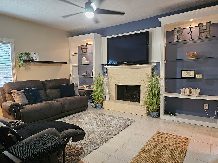 Spacious living and media room with fireplace and built-ins. Comfortability for rest, quiet evenings, and decompression.