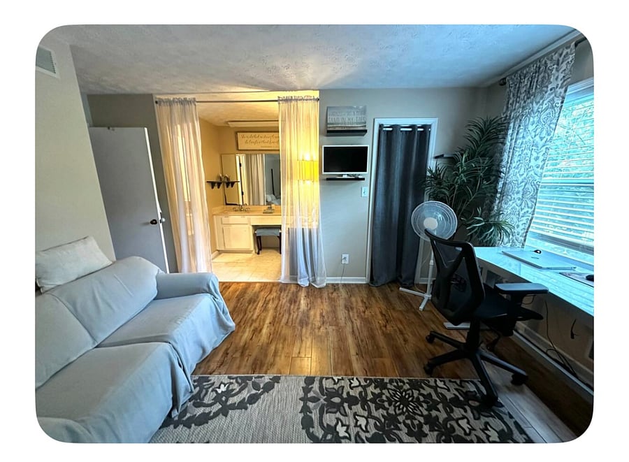Alternative view of the primary bedroom featuring natural light and a space for seating area and/or quite workspace