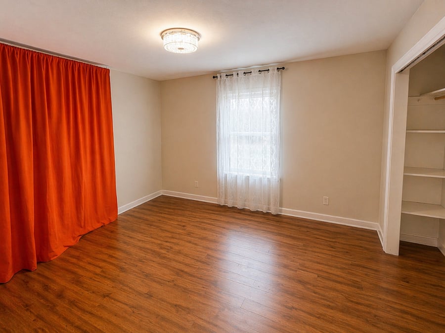 Empty 3rd bedroom showcasing natural light and a warm, inviting atmosphere ready to be personalized to your needs.