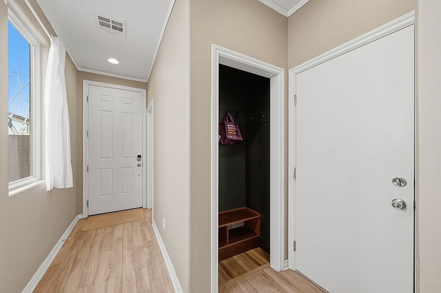 Front door hallway with closet for shoes and misc clothing items and door to garage 