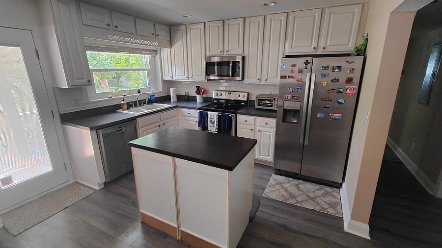 Kitchen with full sized refridgerator, glass top stove, oven, microwave, toaster oven, dishwasher and double sink.