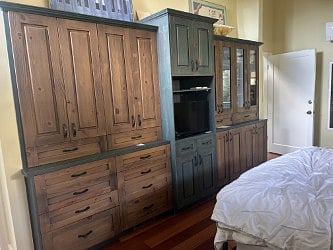 Small TV and built in dresser drawers and cupboard space.
