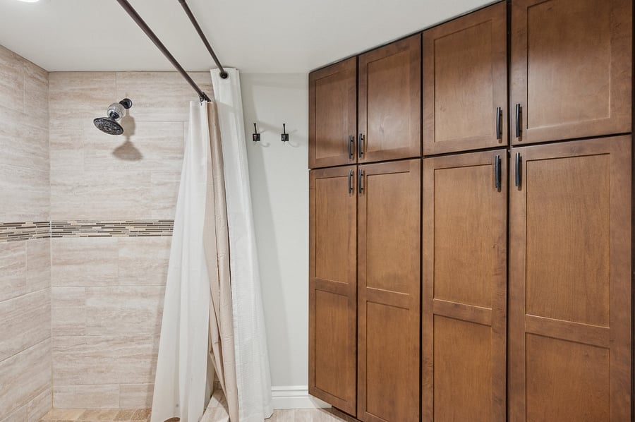 Private toilet/ shower area with floor to ceiling storage.