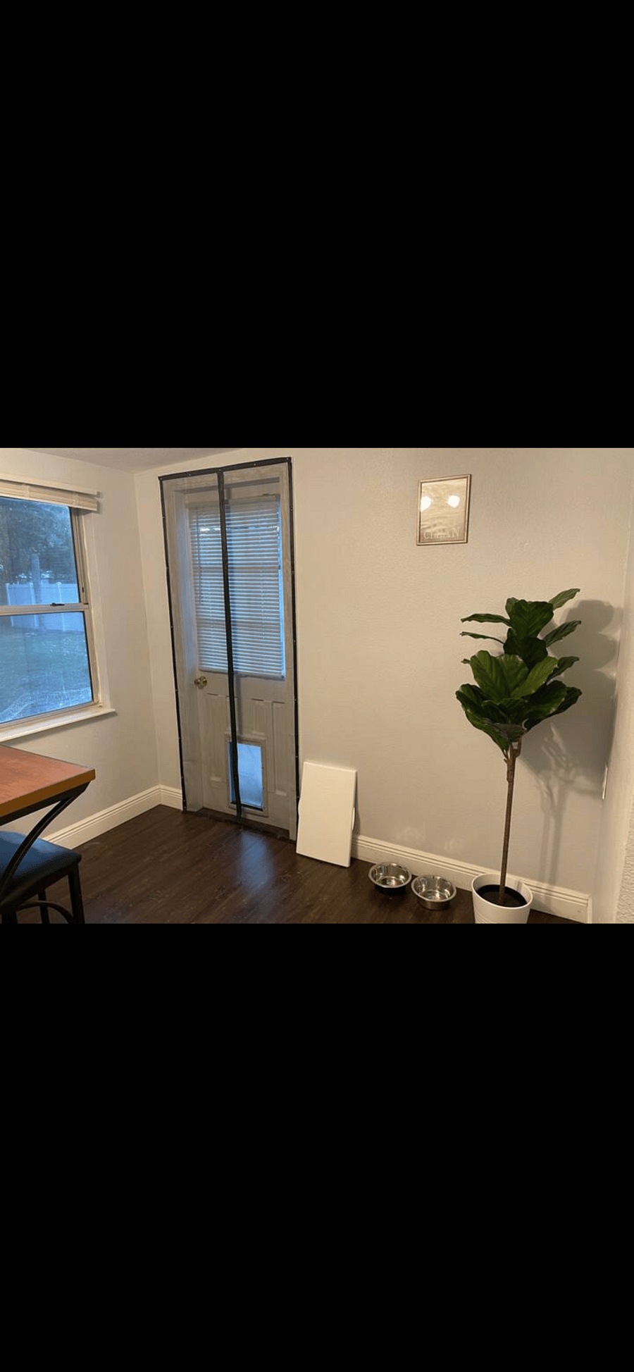 Door leads to fenced in grass area with patio. Doggy door with removable cover.