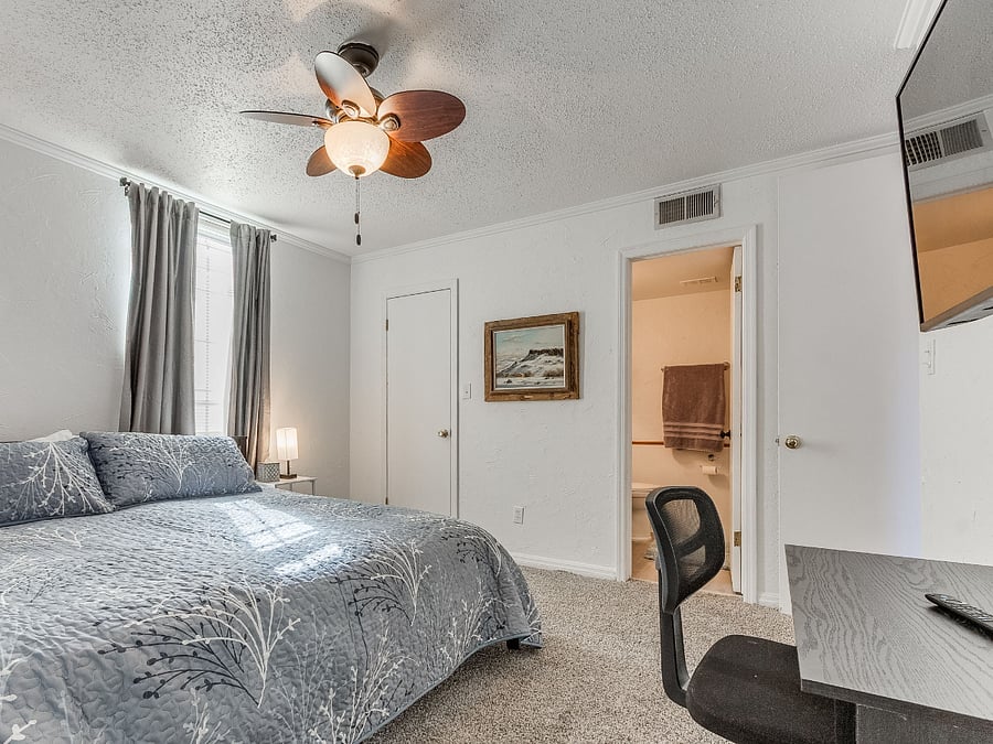Santa Fe suite with locking door, en suite bath with Jacuzzi tub, desk, king size bed, (or twins) TV, chest of drawers, and walk-in closet.