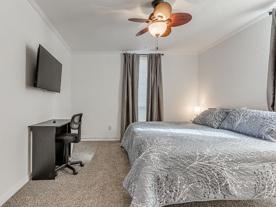 Santa Fe suite with locking door, en suite bath, with Jacuzzi, desk, TV, chest of drawers, and walk-in closet.