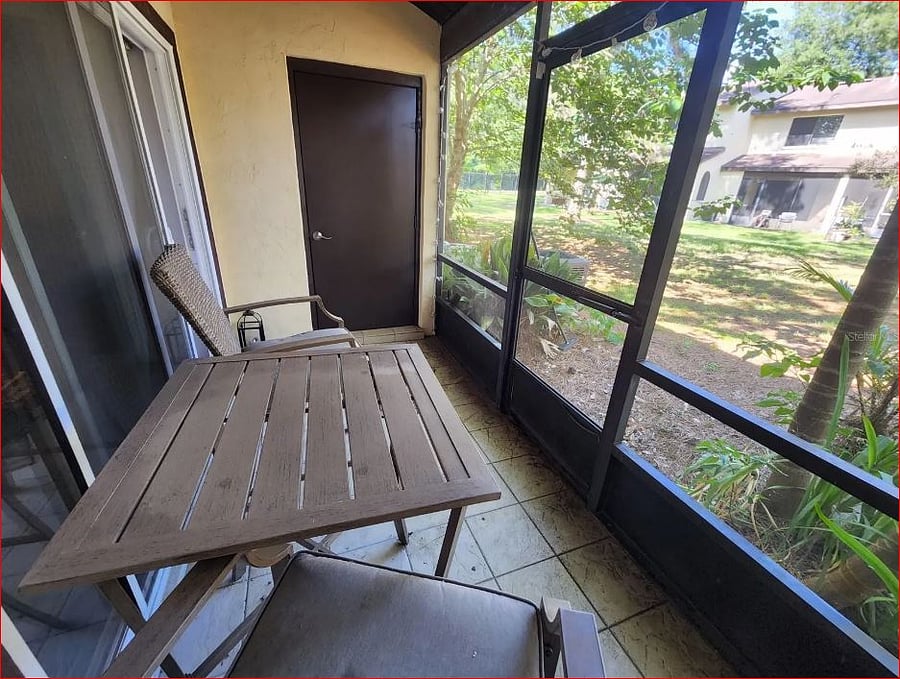 Rear screened porch - Door is to storage room