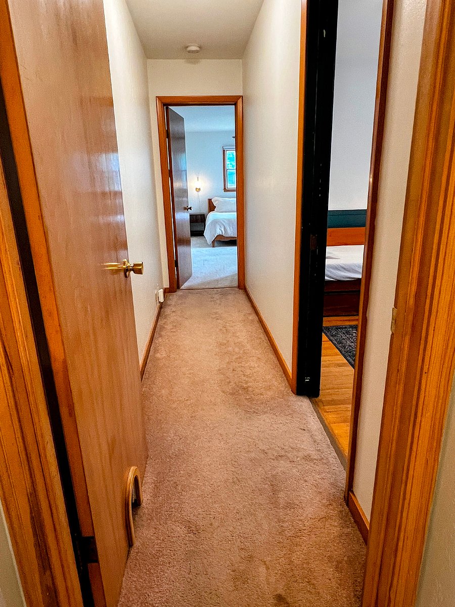 From the bathroom, a hallway leads to the three bedrooms. 