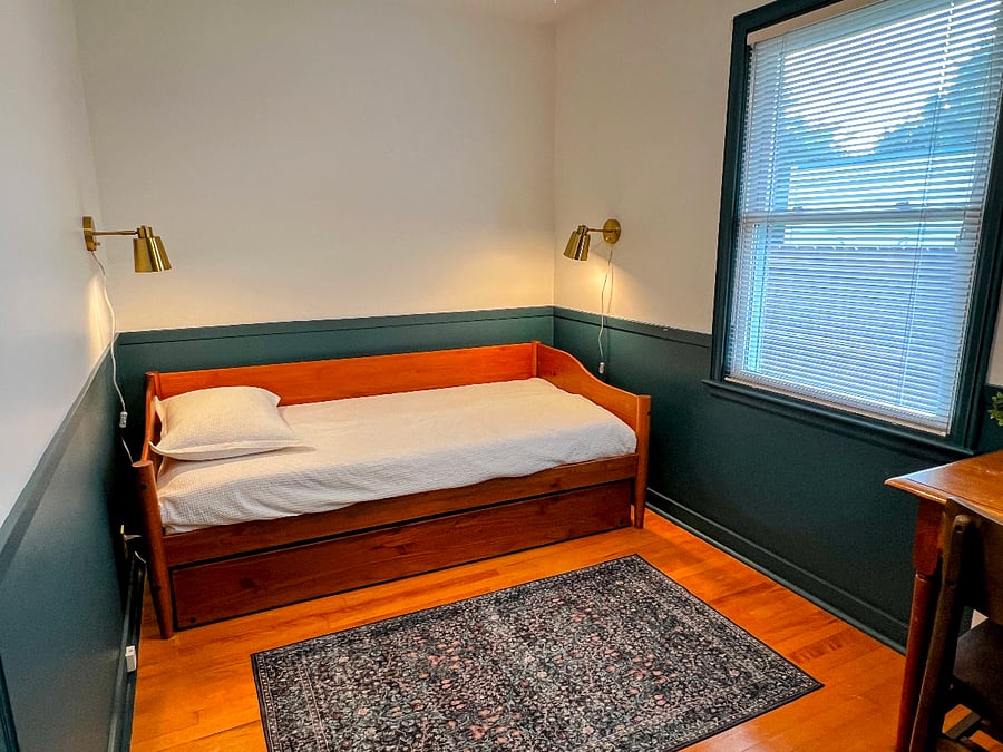 The middle bedroom has a daybed with a trundle. The main floor of the house can sleep up to six people.