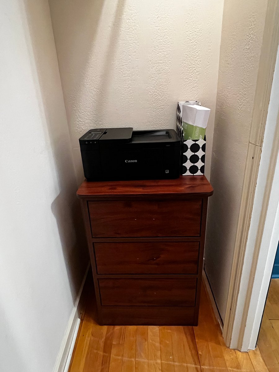 The middle bedroom closet has a small dresser and a wireless printer that can be taken out and plugged in. The closet also has ample storage.