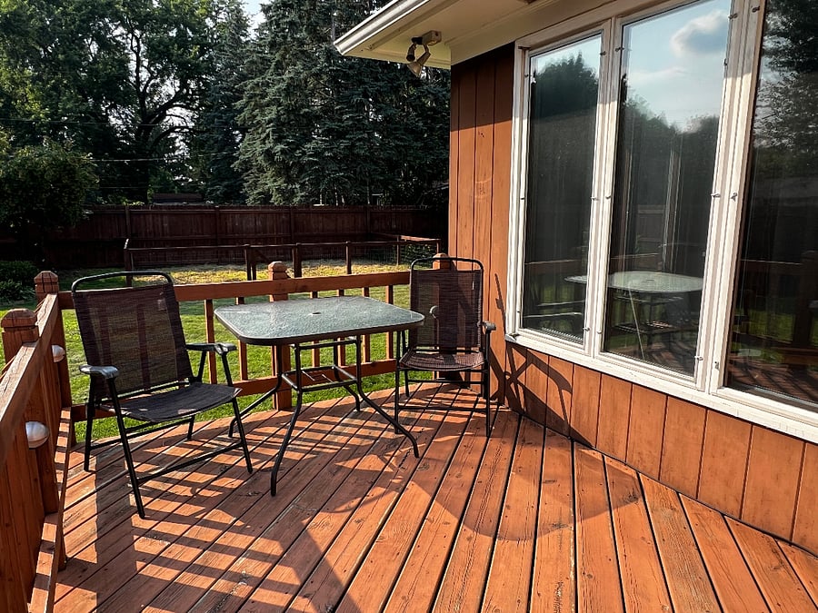 The deck is off of the kitchen and the study and overlooks the fenced backyard.