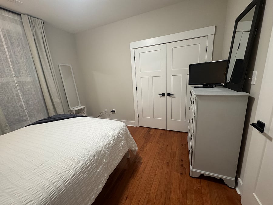 Bedroom with dresser and TV with Roku