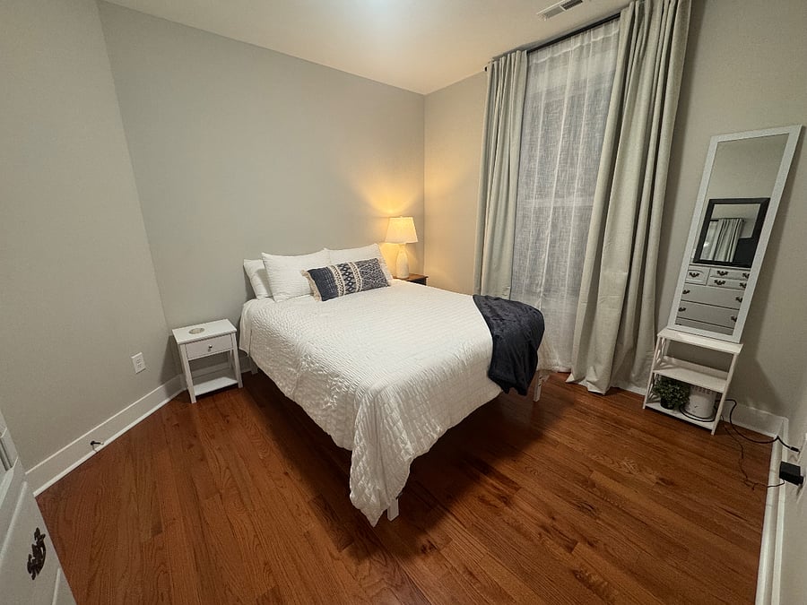 Cozy bedroom with queen bed and full sized mirror