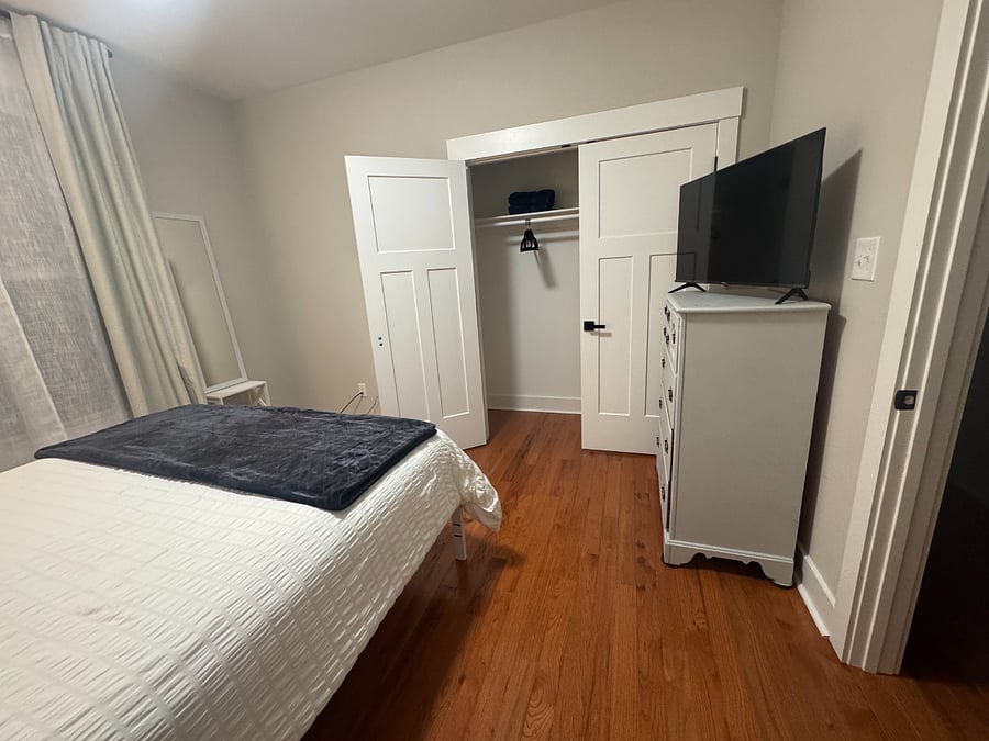 Bedroom A with dresser and TV. Available September 1.
