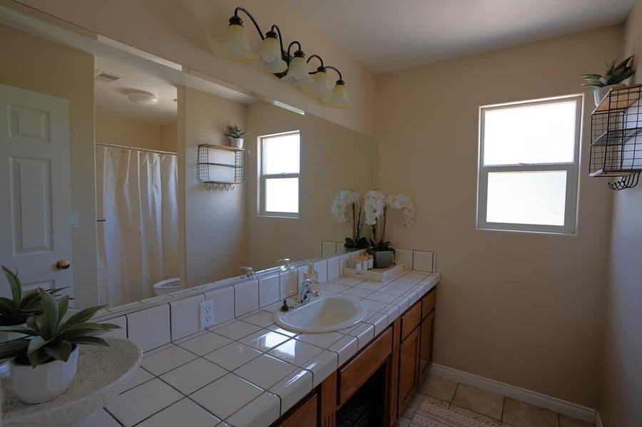 Shared restroom with the pink and white room.