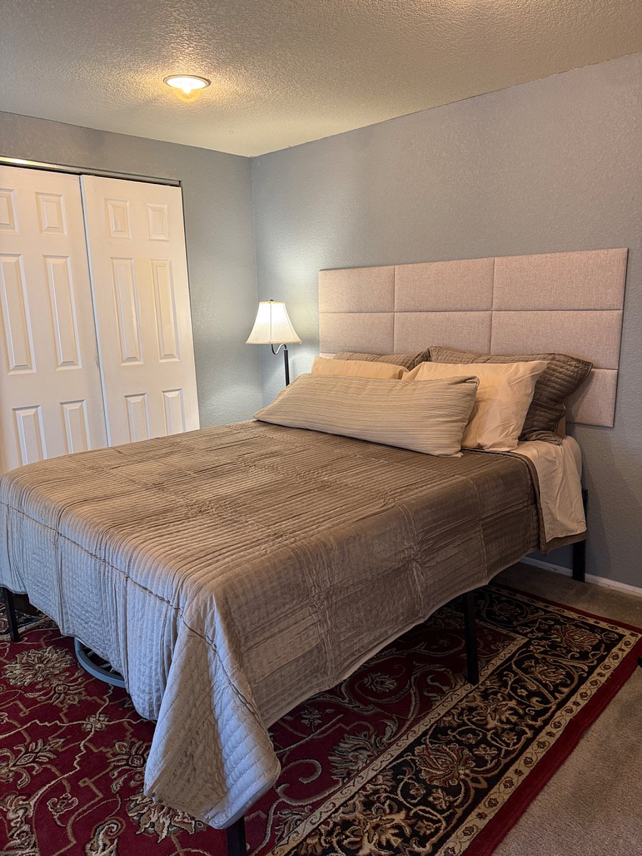 The second bedroom with a walk out slider to the yard with a new queen bed.