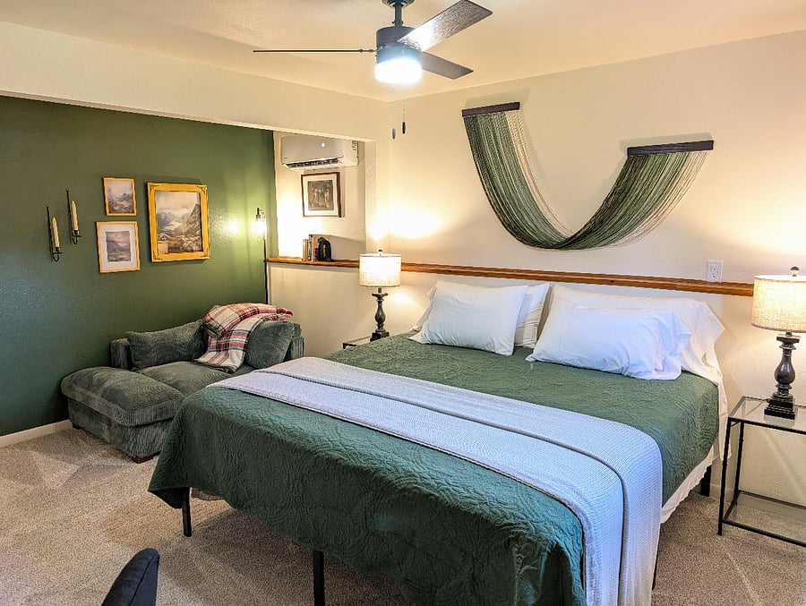 Primary basement bedroom has a king-size bed, 43" Roku Smart TV, a desk workspace, walk-in closet, connected to the basement bathroom.