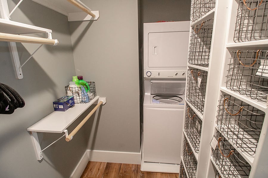 En-suite walk-in closet with stackable washer and dryer.