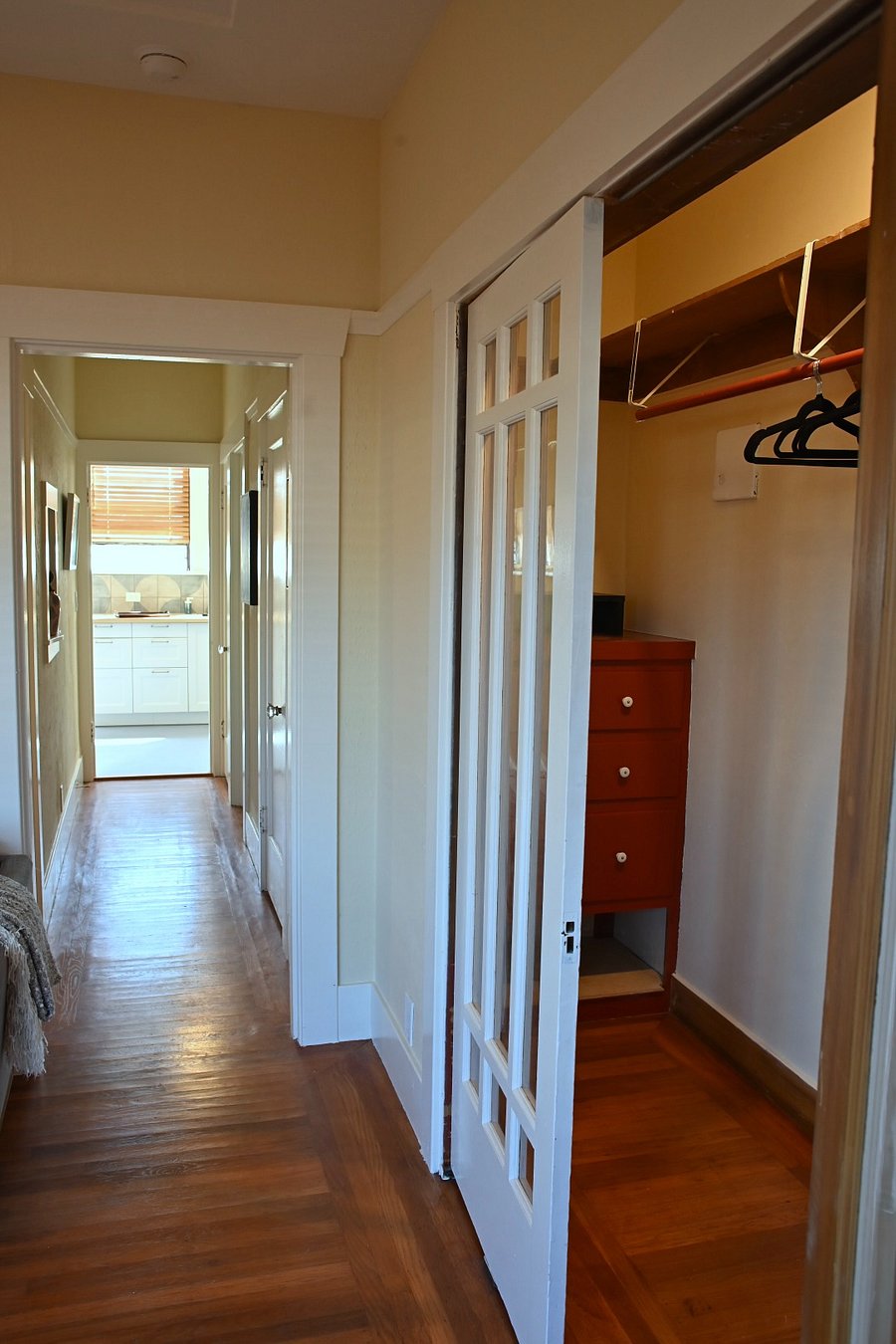looking down hall from LR to kitchen, walkin closet on the right