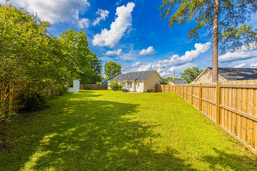 Large, grassy yard ideal for relaxing, reading, or taking in fresh air. fully fenced for privacy.