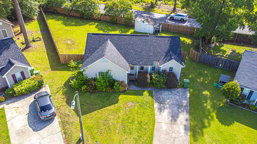 A clear look at the homes layout, driveway, and quiet surrounding streets.