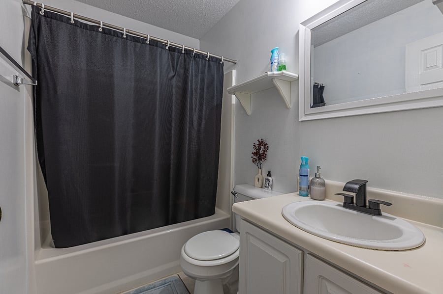 Clean, modern bathroom with tub/shower combo and all essentials provided.