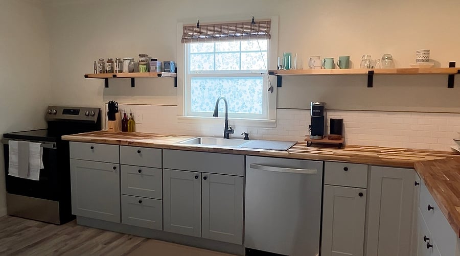 The kitchen is spacious & well-equipped. The stove is an electric, glass-top. The dishwasher is full sized. The refrigerator is a French door model, which allows different items to be stored at different temperatures.